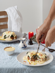 Eggs Benedict with Dutch egg and butter sauce and red caviar. Close-up. Tasty breakfast with poached eggs. Vertical orientation.