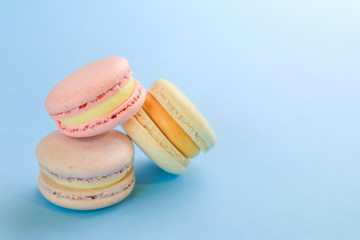 Tasty sweet macaron cakes on color background