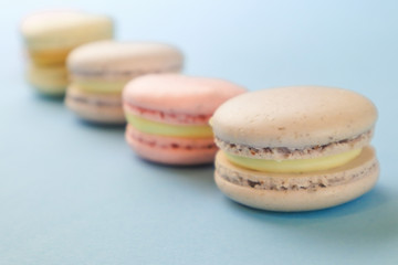 Tasty sweet macaron cakes on color background