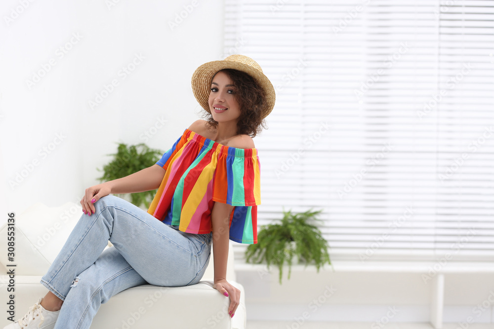 Sticker Beautiful woman in casual outfit on sofa indoors. Space for text