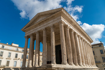 Fototapeta premium Maison Carree - restored roman temple dedicated to princes of youth, with richly decorated columns and friezes in Nimes, France