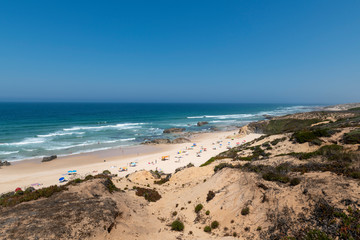 People at the Malhao Beach (Praia do Malhao) in Porto Covo, in Alentejo, Portugal.