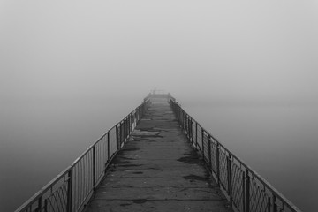 Old abandoned pier in the fog