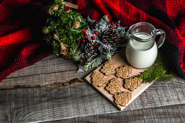 Fresh milk and Christmas cookies with Christmas decorations on a wooden table