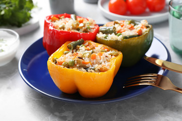 Tasty stuffed bell peppers on grey table