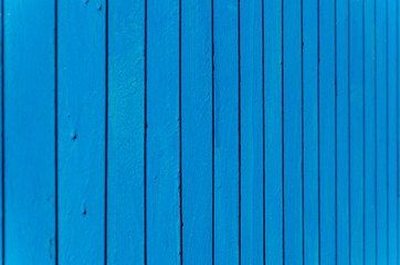 blue background with vertical lines. metal fence