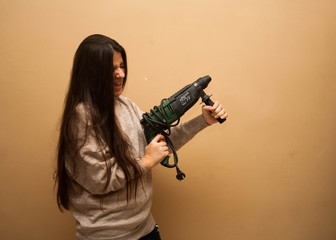 Young girl with a drill