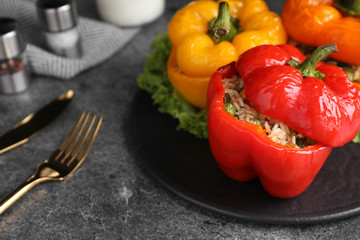 Fototapeta na wymiar Tasty stuffed bell peppers on grey table, closeup