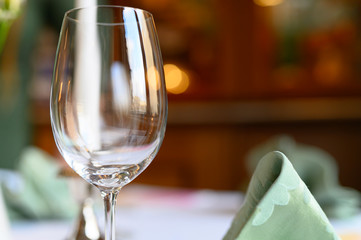 empty wineglass closeup on a background of holiday restaurant. waiting for the holiday