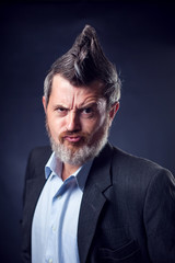 A portrait of bearded man with iroquois wearing suit