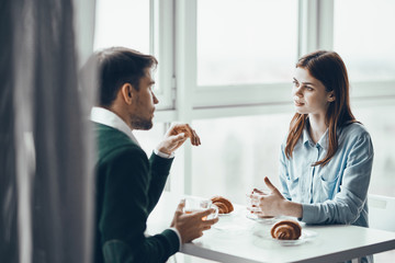 young couple having breakfast in the kitchen