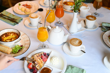 morning Breakfast or brunch in the restaurant. table with drinks and food. selective focus