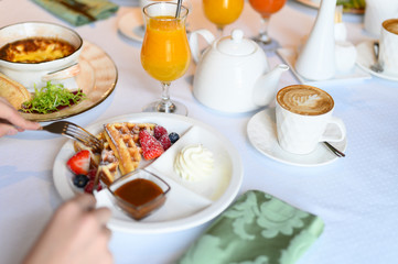 morning Breakfast or brunch in the restaurant. table with drinks and food. selective focus