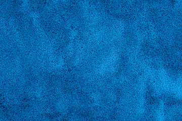 Texture of coastal wet sea sand toned in classic blue. Color of the year 2020. Colorful concept.
