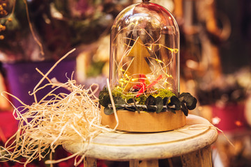 small wooden Christmas tree inside a glass container