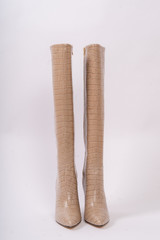 Womens beige boots, isolated on white background.