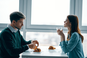 young couple having breakfast in restaurant