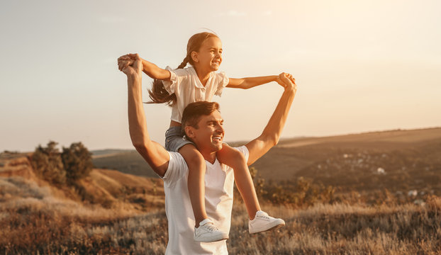 Father and daughter enjoying freedom in nature