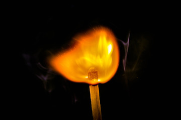 burning match on black background
