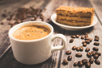 Honey cake and a cup of coffee on a wooden table