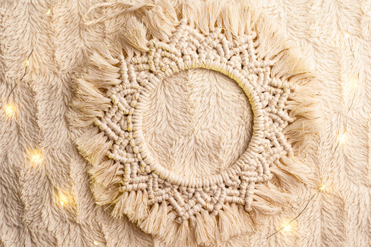 Handmade macrame  circle decoration on artificial fur. Top view.