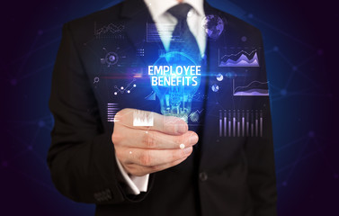Businessman holding lightbulb with EMPLOYEE BENEFITS inscription, Business idea concept