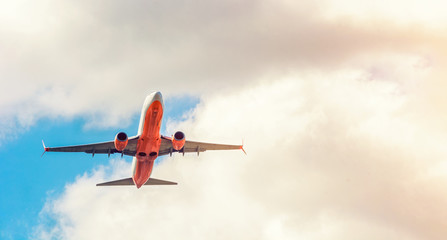 A large white passenger plane takes off. Cargo and passenger transportation. Flight to the summer resort. Clear blue sky. Airplane in the sky.