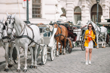 Naklejka na ściany i meble Woman walking in city. Young attractive tourist outdoors in italian city