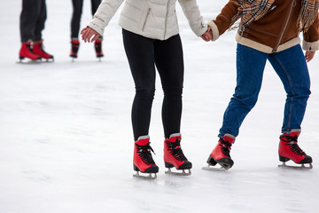 people ice skating on an ice rink. Hobbies and sports. Vacations and winter activities.