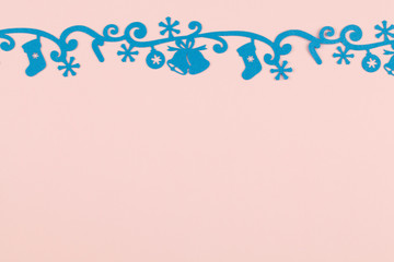 Christmas background with blue felt decoration on pink background.
