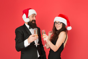 Christmas is coming. xmas party. formal couple in love celebrate new year. tuxedo man with woman in santa hat. merry christmas and cheers everyone. business man and girl drink champagne