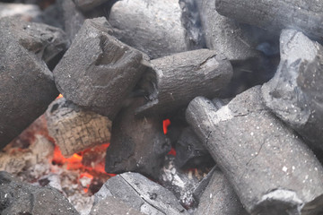 Fototapeta na wymiar Natural Black Burning Glowing Charcoal and Freshly Added Coal With Fire Lit