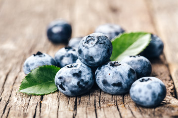 Freshly picked blueberries on wooden background. Healthy eating and nutrition.