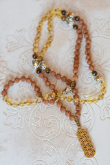 Spiritual mala bead necklace with natural mineral stone beads on wooden decorative background