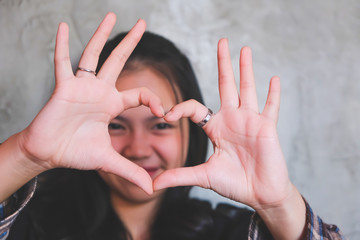 Asian teenage girls hand in heart shape with love Valentines Day.