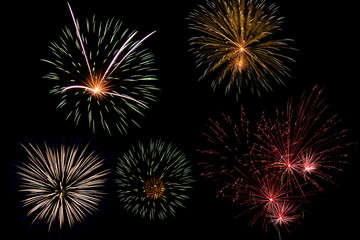 Festive patterned firework bursting in various shapes sparkling pictograms set. Colorful assorted fireworks selection on a black background.