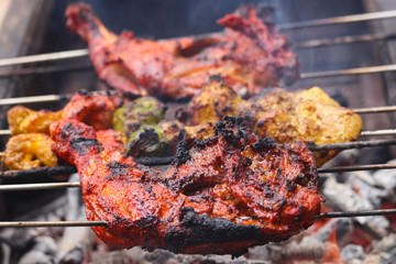 Selected Focus on Grilled Chicken Breast Non Veg Barbeque BBQ Roasted on Smoking Hot Charcoal Close-Up