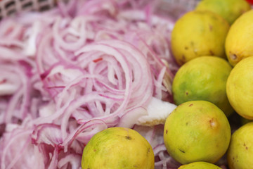 Selected focus on Yellow Lemon and Blur Onion Slices in Background