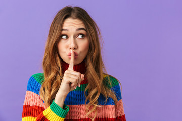 Cute young girl wearing colorful sweater standing isolated