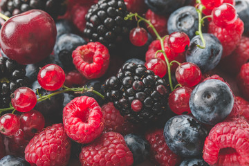 Fresh Summer Berries mix Background with Strawberry, Raspberry, Red currant, Blueberry and Blackberry.