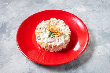Traditional Russian Christmas Salad - Olivier on concrete background