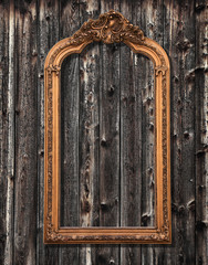 Classic mirror frame on a grungy wooden wall