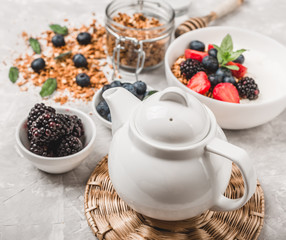 Obraz na płótnie Canvas Healthy breakfast with granola, yogurt, fruits, berries on white background.