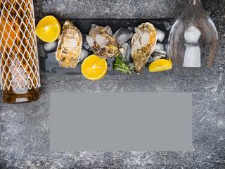 Oyster on ice, lemon slices, wine bottle and glass. Delicatessen and gourment food, rich in iodine, antioxidants, zinc