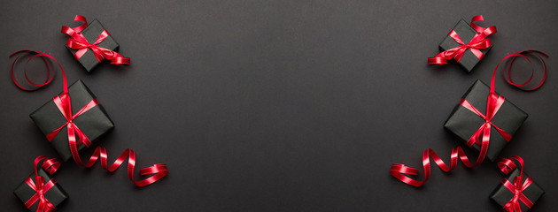 Xmas decoration. Red Christmas gifts, ornaments on black backgro