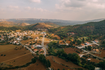 Old village in Cyprus mountains Mosfiloti or Mosfilioti, aerial view. Beautiful old houses in valley.
