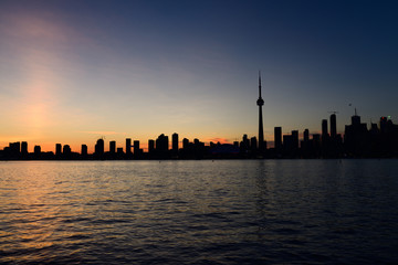 Silhouette of Toronto city skyline after red sunset on Lake Ontario