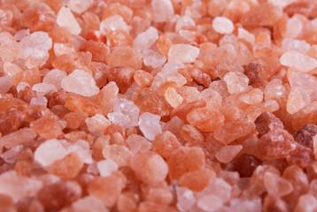 Fototapeta na wymiar Background of pink Himalayan salt close-up view from above