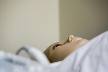 Obraz na płótnie Canvas Medical dummy reeling in hospital bed
