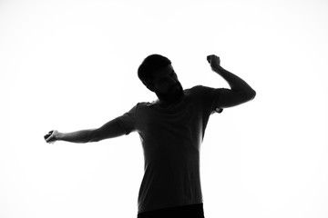 silhouette of man with arms raised